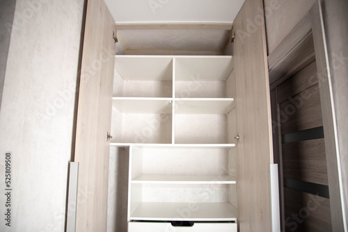 Modern closet in the hallway with hinged doors and pull-out shelves. Production of furniture under the order. photo