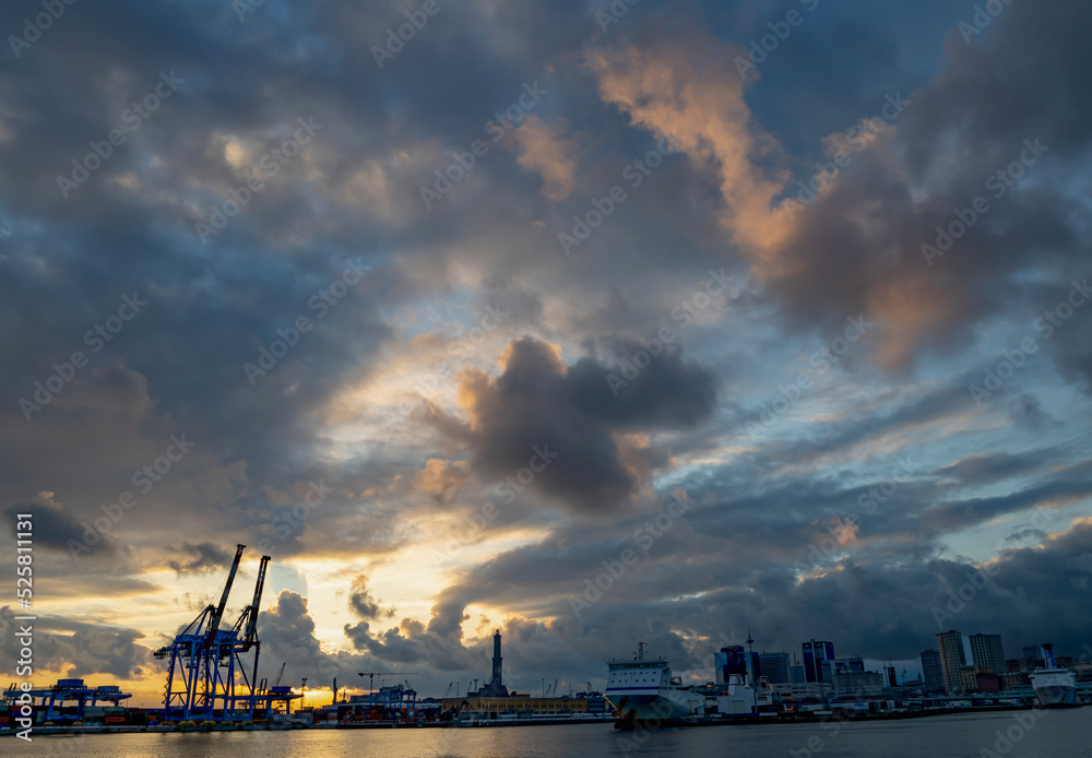 GENOA, ITALY, JANUARY 23, 2022 - Sunset with cloudy sky in the Ancient Port of Genoa, Italy