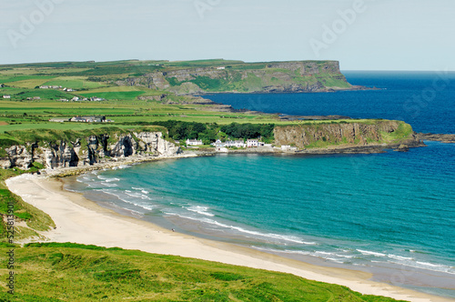 White Park Bay on the Giants Causeway Coast of County Antrim, Ireland. Looking to Portbraddon village and the Causeway headlands