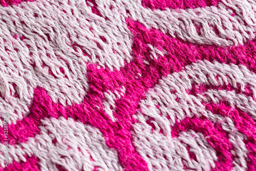 texture of burgundy terry towel with a pattern, close-up. Background, vinous