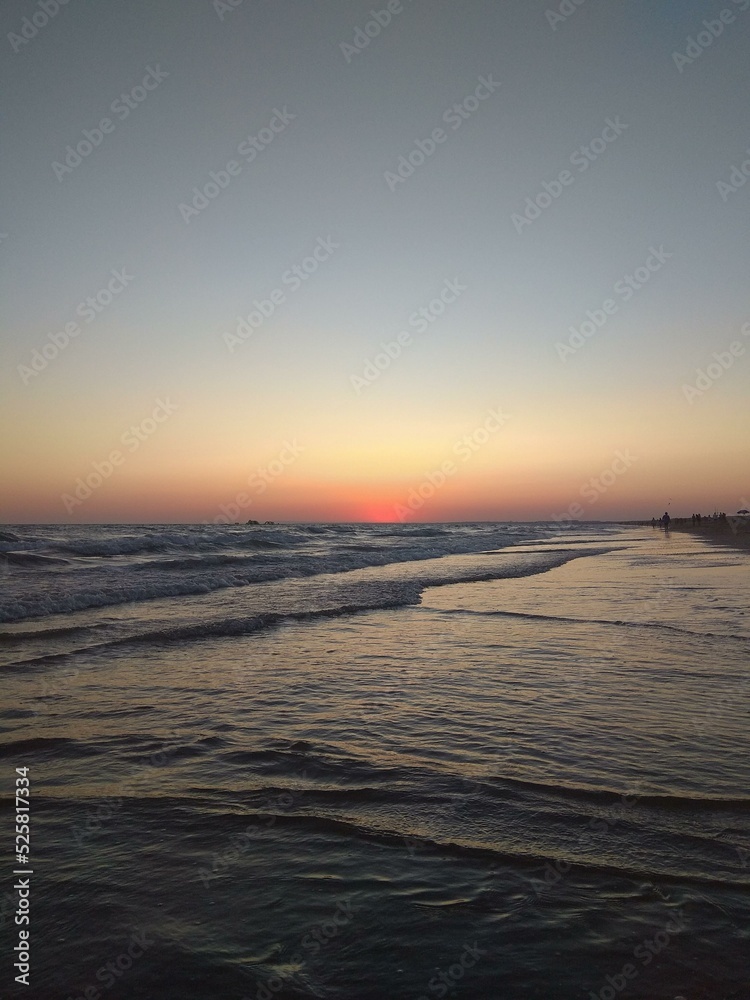 Fototapeta premium Sunset at the beach with silver waves