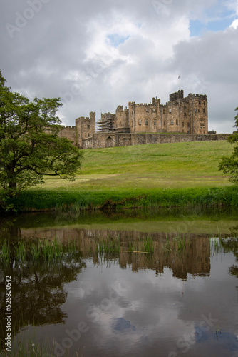 Alnwick Castle reflected in the water of the River Aln. Northumberland  UK