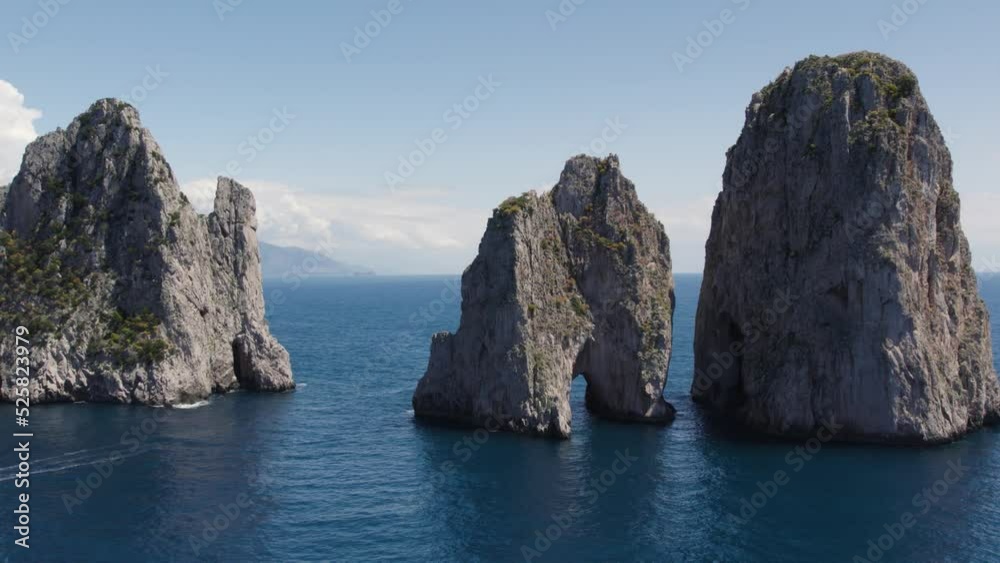 Low aerial of dramatic limestone masses (Faraglioni) on Capri coastline Low aerial of dramatic limestone masses (Faraglioni) on Capri coastline