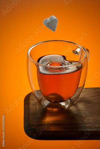 A cup of tea and a piece of sugar