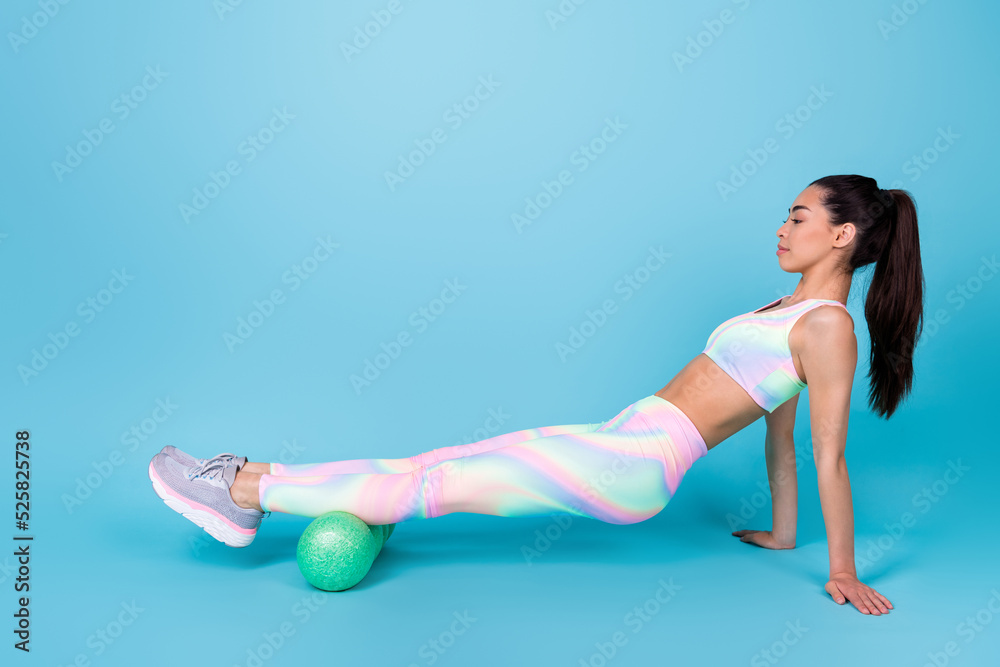 Full body profile photo of cute chinese lady strength exercise sport roll wear stylish sporty look isolated on shine blue color background Full body profile photo of cute chinese lady strength exercise sport roll wear stylish sporty look isolated on shine blue color background