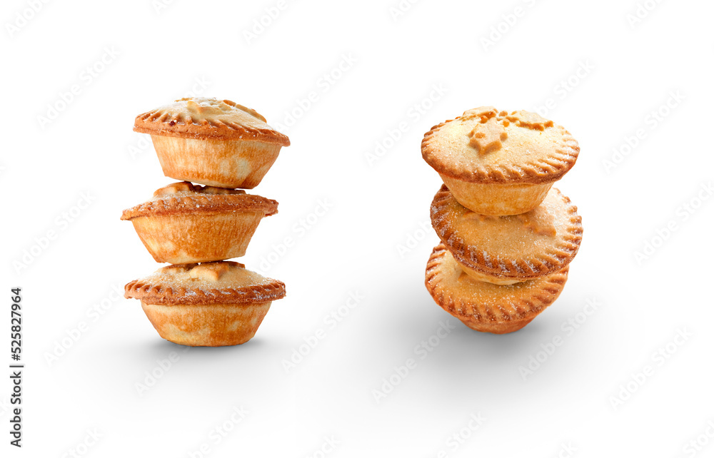 A collection of Christmas mince pies staked, piled up isolated against a flat background.