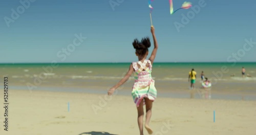 MS TS Girl (6-7) running with ribbon on beach