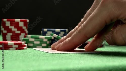 A close-up of checking poker pair of cards. Two red aces. Chips on a background.