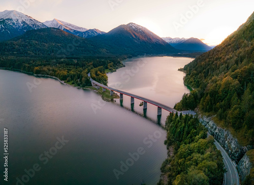 Scenic view of country road and lake Sylvenstein Speicher, Bavaria, Germany photo