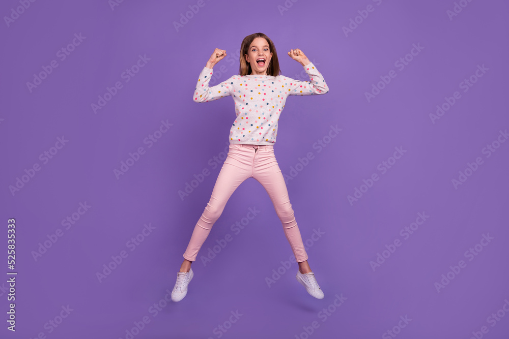 Full size photo of delighted overjoyed girl jump raise fists celebrate triumph isolated on violet color background