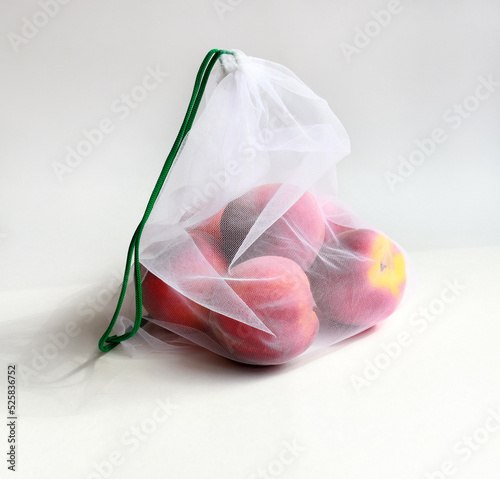 peaches in a white eco bag