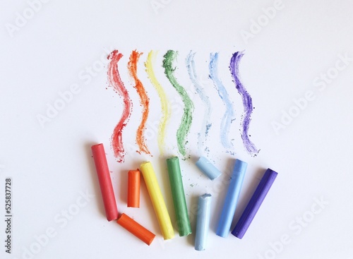 Multi-colored pastel crayons on a white background. Rainbow Colors. Art materials for school and hobbies.	