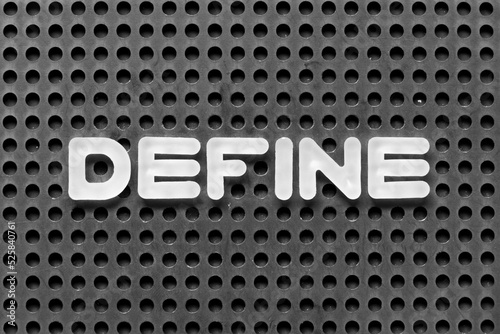 White alphabet letter in word define on black pegboard background