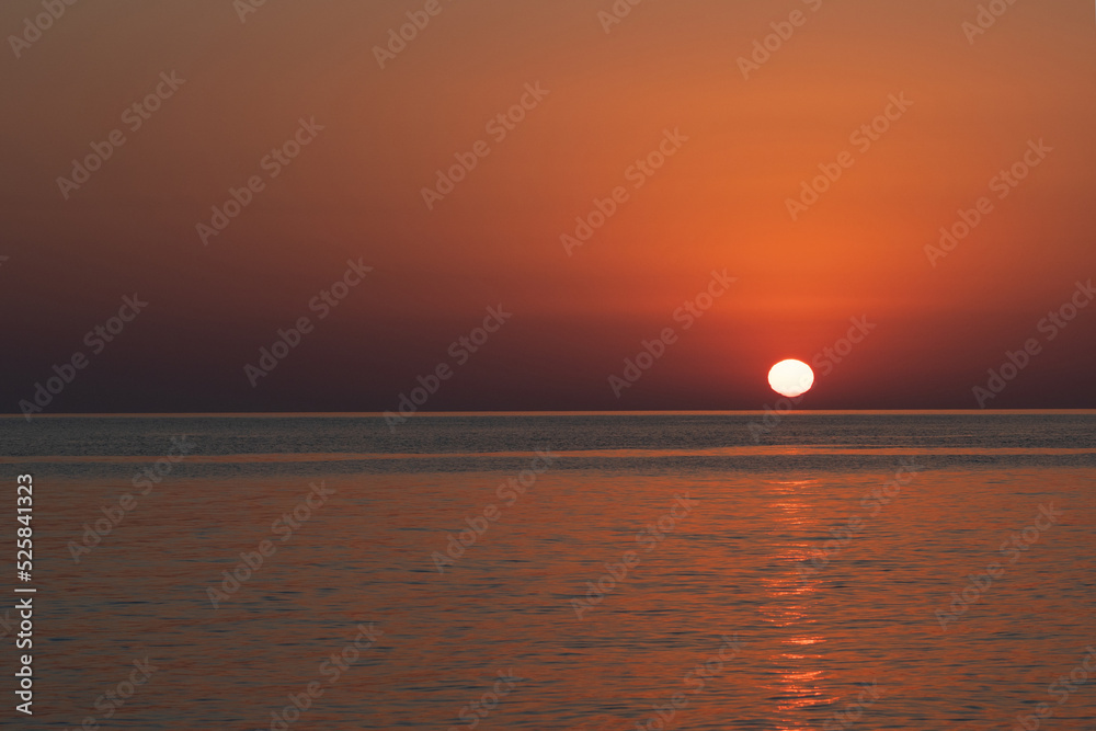 Pink sunset in the sea, gentle romantic natural background. Unity with nature