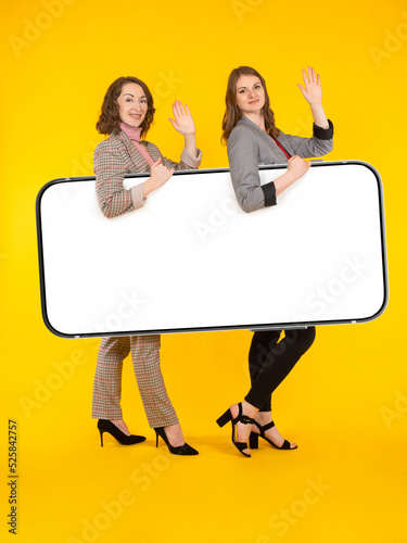 Big phone. Two woman with h...