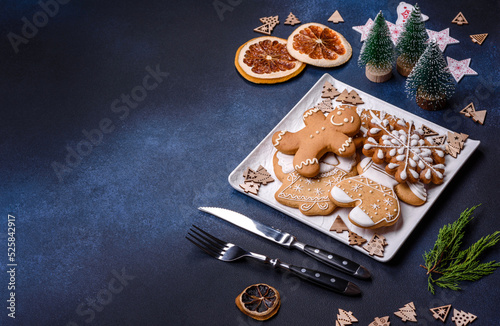 Christmas decorations and gingerbreads on a dark concrete table. Getting ready to celebration © chernikovatv