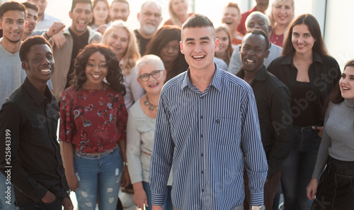Принти на полотні confident man standing in front of a team of young like minded people