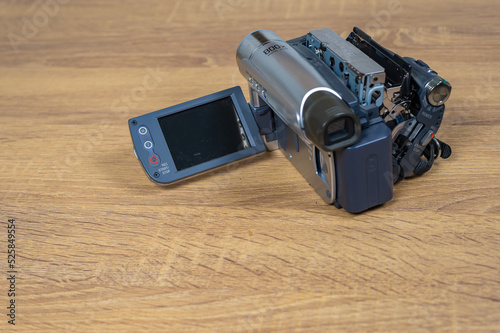 Handycam, Camcorder, Video camera record on a wooden table, Vintage video camera style, Recording memory concept, Old school style, Mini dv, Retro video camera.