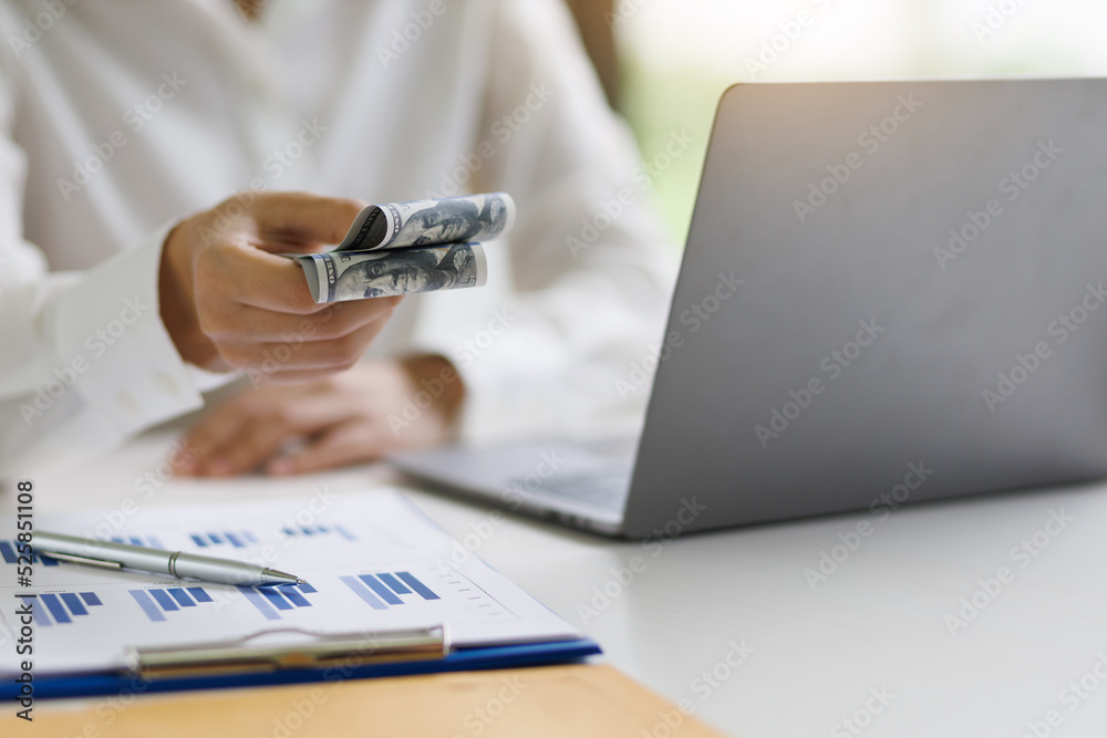 Woman holding cash banknotes showing wages. Woman holding cash banknotes showing wages.