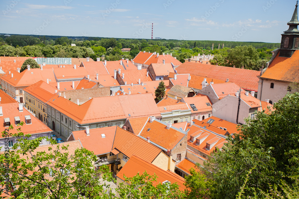 Old town of Austro-Hungarian style residential houses, panoramic view of roofs, below of Petrovaradin fortress by Danube river, Novi sad, Serbia.	
