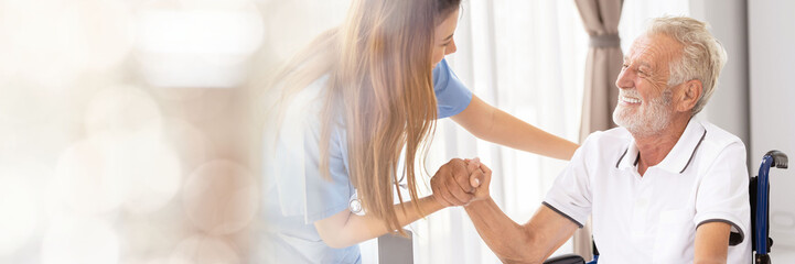 Web banner Man being cared for by a private Asian nurse at home suffering from Alzheimer's disease to closely care for elderly patients with copy space on left