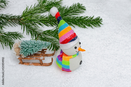New Year is coming concept. Snowman with sled and New Years tree