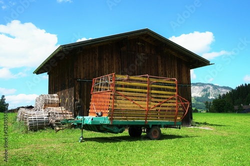 Wooden shed on a meadow under a blue sky photo