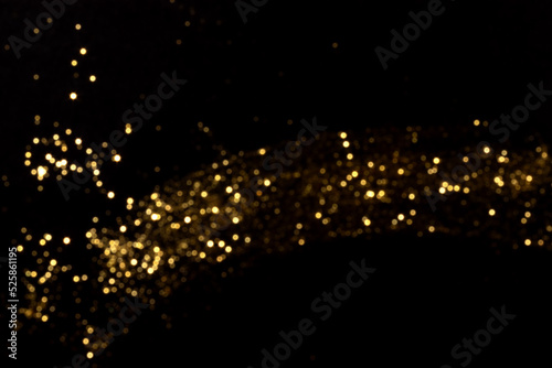 Golden blurred bokeh lights on black background. Glitter sparkle stars for celebrate. Overlay for your design