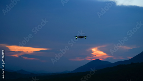Silhouette of a drone during the sunset or sunrise  unmanned aerial vehicle in the outdoor