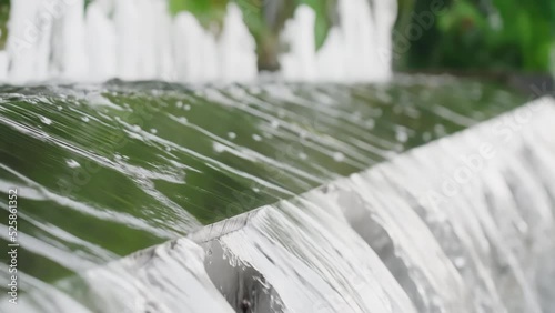 Beautiful fountains in the park of Jakarta, Indonesia. Urban oasis of peace and beauty in the centre of the city. Slow motion.  photo