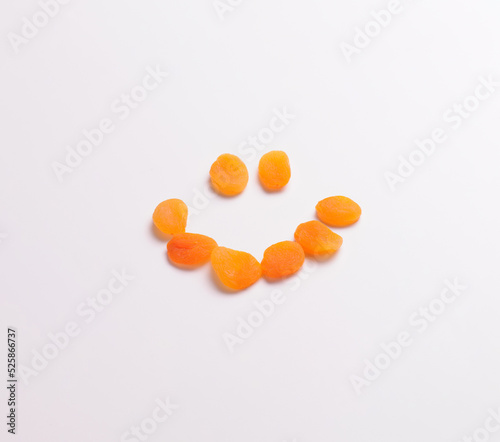 Dried apricots forming a smiley face, isolated on white, for mock ups and photo montages