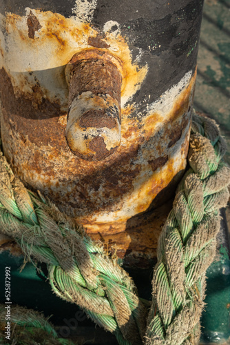rusty bollard and rope on ship deck