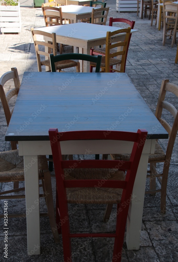 Italy, Salento: Outdoor tables and chairs of a restaurant.