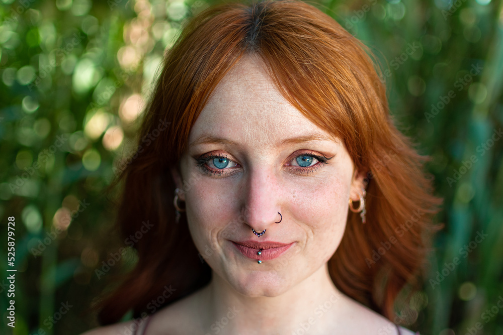 Portraits of a charming red-haired girl with a cute face. Girl posing for the camera in the park. She has a wonderful mood and a lovely smile
Portraits of a charming red-haired girl with a cute face. Girl posing for the camera in the park. She has a wonderful mood and a lovely smile