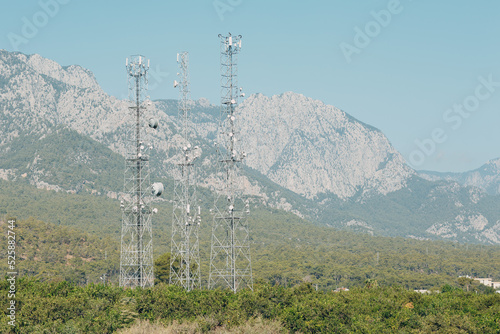Telecommunication antenna tansmitter tower at mountains background