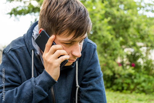Obraz na plátně Sad Young Man with a Phone