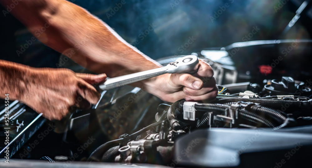 Auto mechanic working in garage. Repair service.