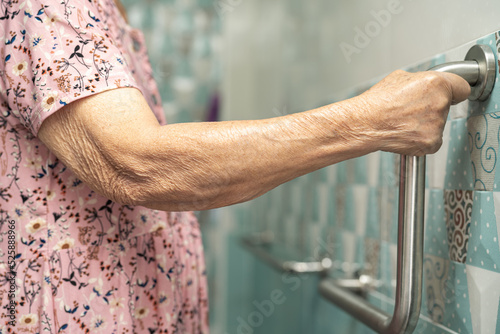 Asian senior or elderly old lady woman patient use toilet bathroom handle security in nursing hospital ward, healthy strong medical concept. © amazing studio