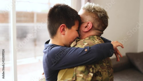 Military soldier father hugging his son after homecoming reunion - Veterans and family love concept photo