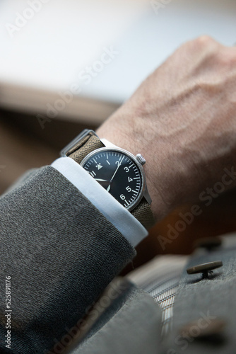 Pilot's watch on man's wrist with Suit