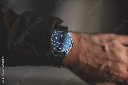 Pilot's watch on man's wrist with jacket, Matte