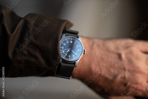 Pilot's watch on man's wrist with jacket