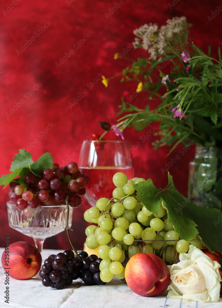 Wine and fruit on a table. Beautiful composition of juicy berries, grapes and rose wine. Harvest celebration. Textured background with copy space. Wine and fruit on a table. Beautiful composition of juicy berries, grapes and rose wine. Harvest celebration. Textured background with copy space.