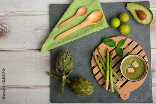 Green kitchen cooking utensils on wooden floor photo