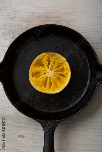 Orange on iron pan wooden floor photo