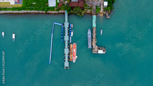 Aerial view from drone of commercial ship and cruise ship parked in the marina. Transportation and travel background, beautiful sea in summer.