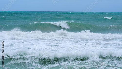 Beautiful ocean waves with blue and turquoise foam on a hot summer day.