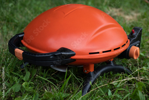 Orange grill. Gas grill for frying food. Picnic details.