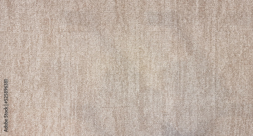 close up of monochrome beige or brown carpet texture background from above. texture tight weave carpet. the light color background of the carpet. photo