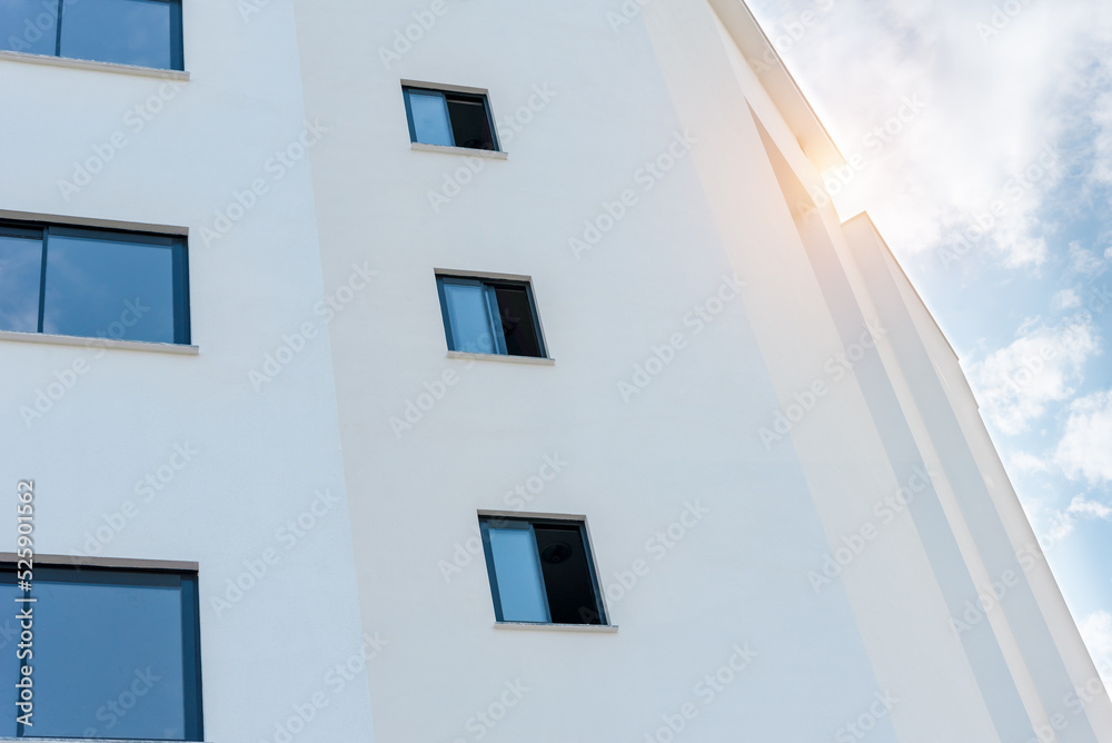 Low angle view of a white apartment building.